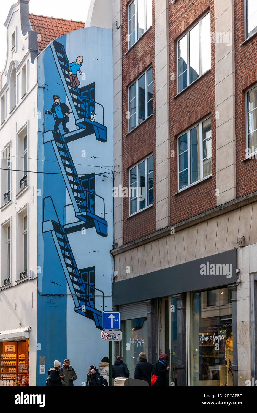 Famous mural of TinTin, captain Haddock and Snowy descending stairs as a wall mural in Brussels opposite the mannequin pis. Stock Photo