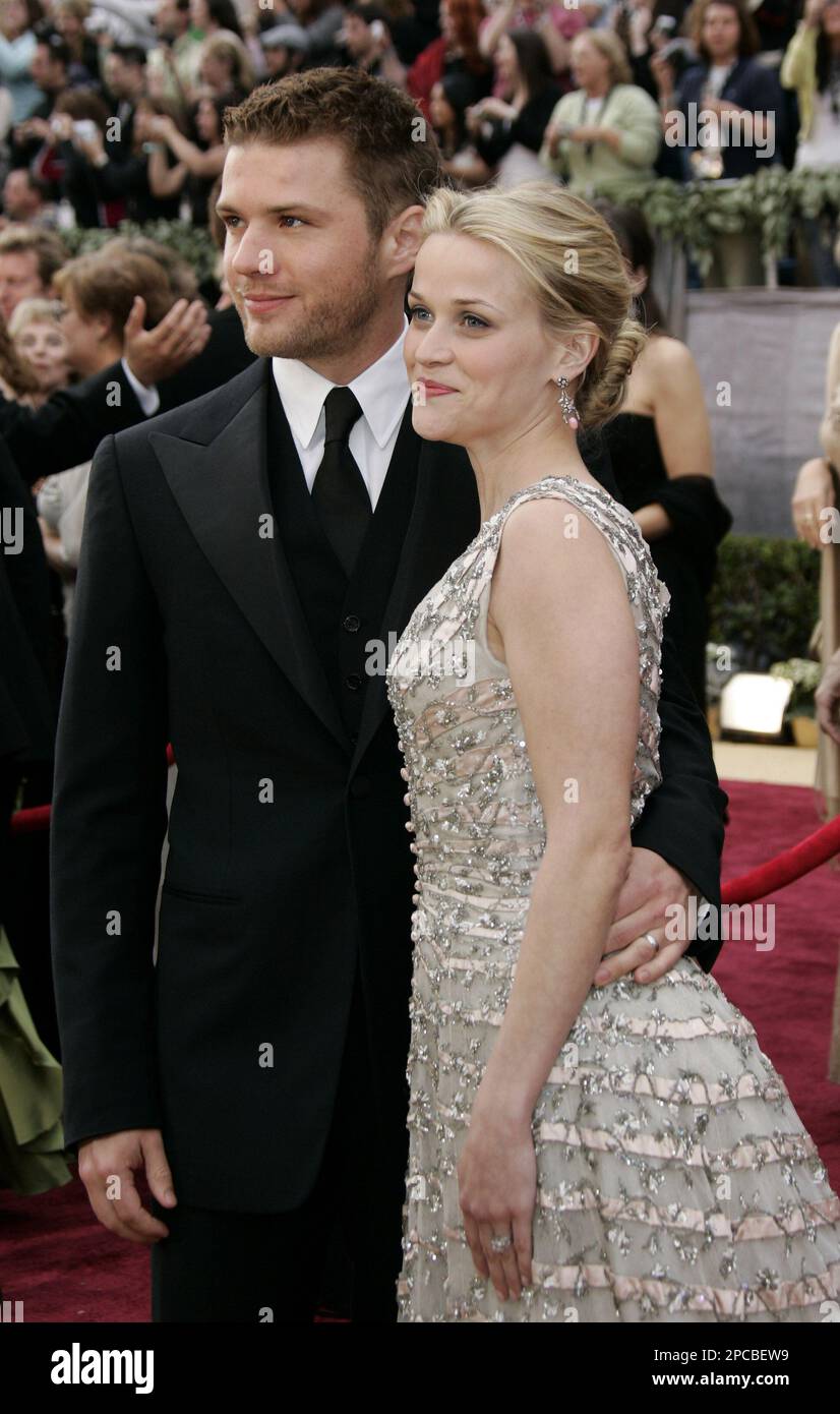 Actress Reese Witherspoon and her husband Actor Ryan Phillippe pose at