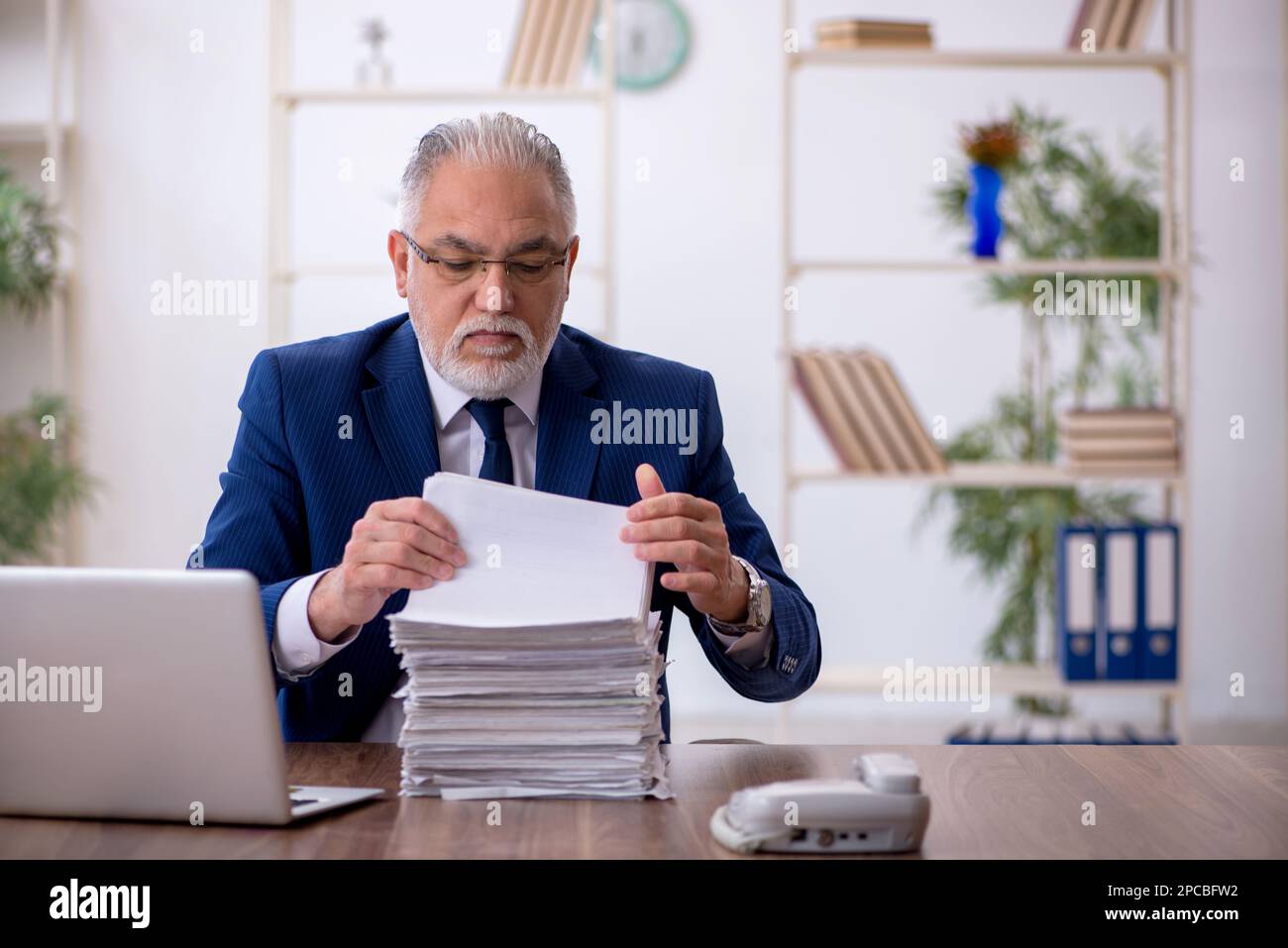 Old businessman employee working at workplace Stock Photo - Alamy