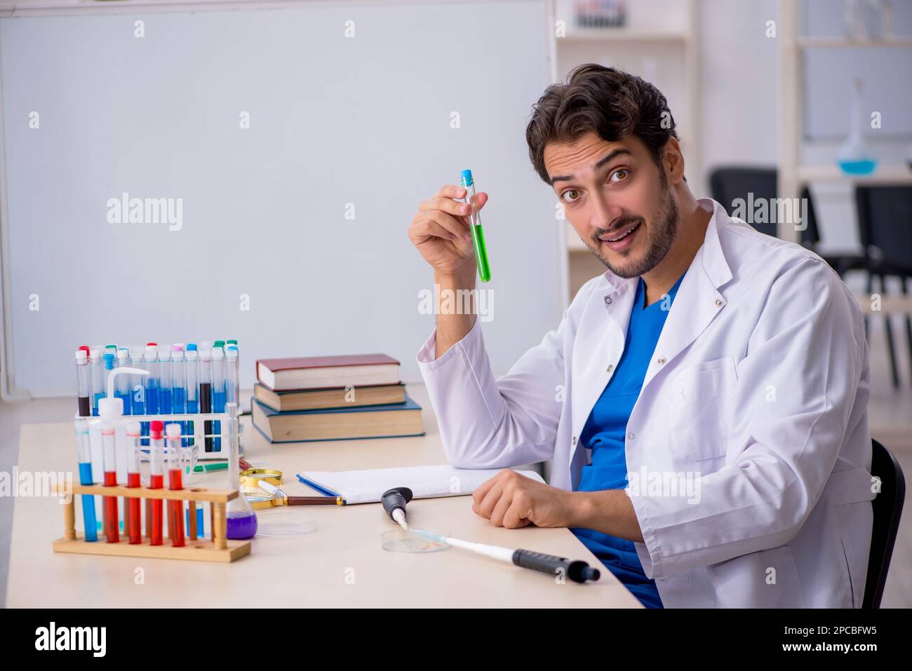 Young chemist working at the lab Stock Photo