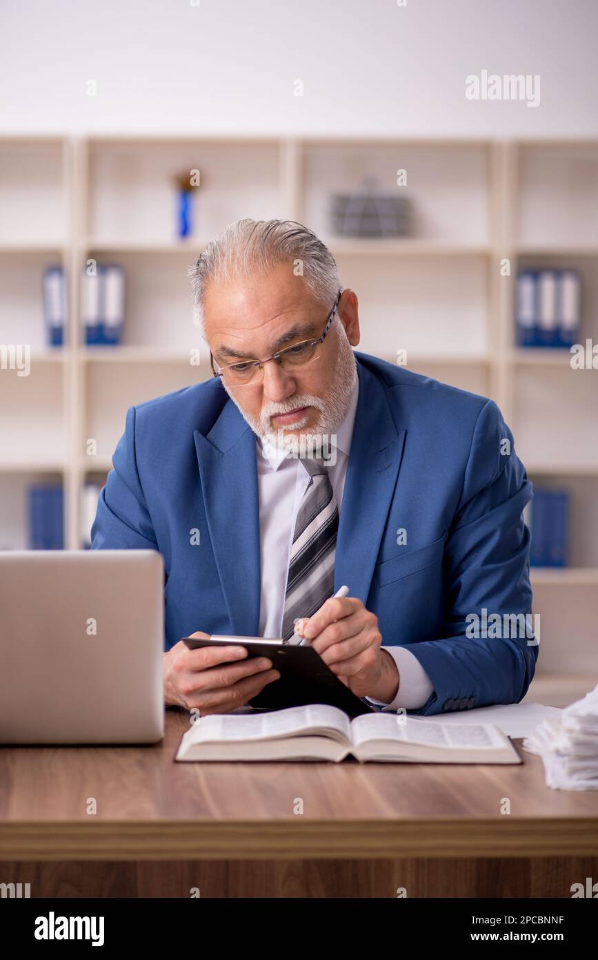 Old businessman employee working at workplace Stock Photo - Alamy