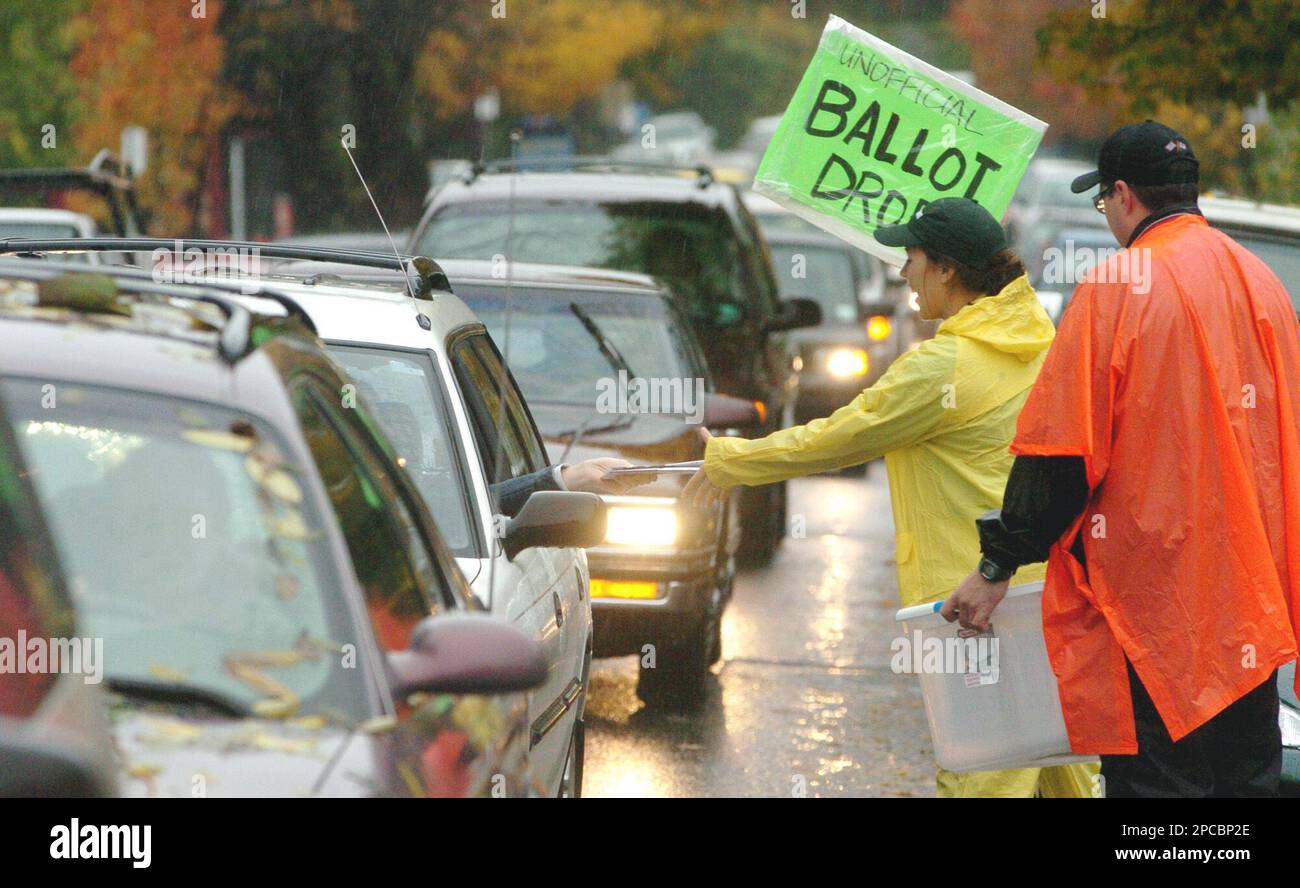 Volunteers, Jesse right, and Stacy Chamberlain, create an unofficial ballot drop off