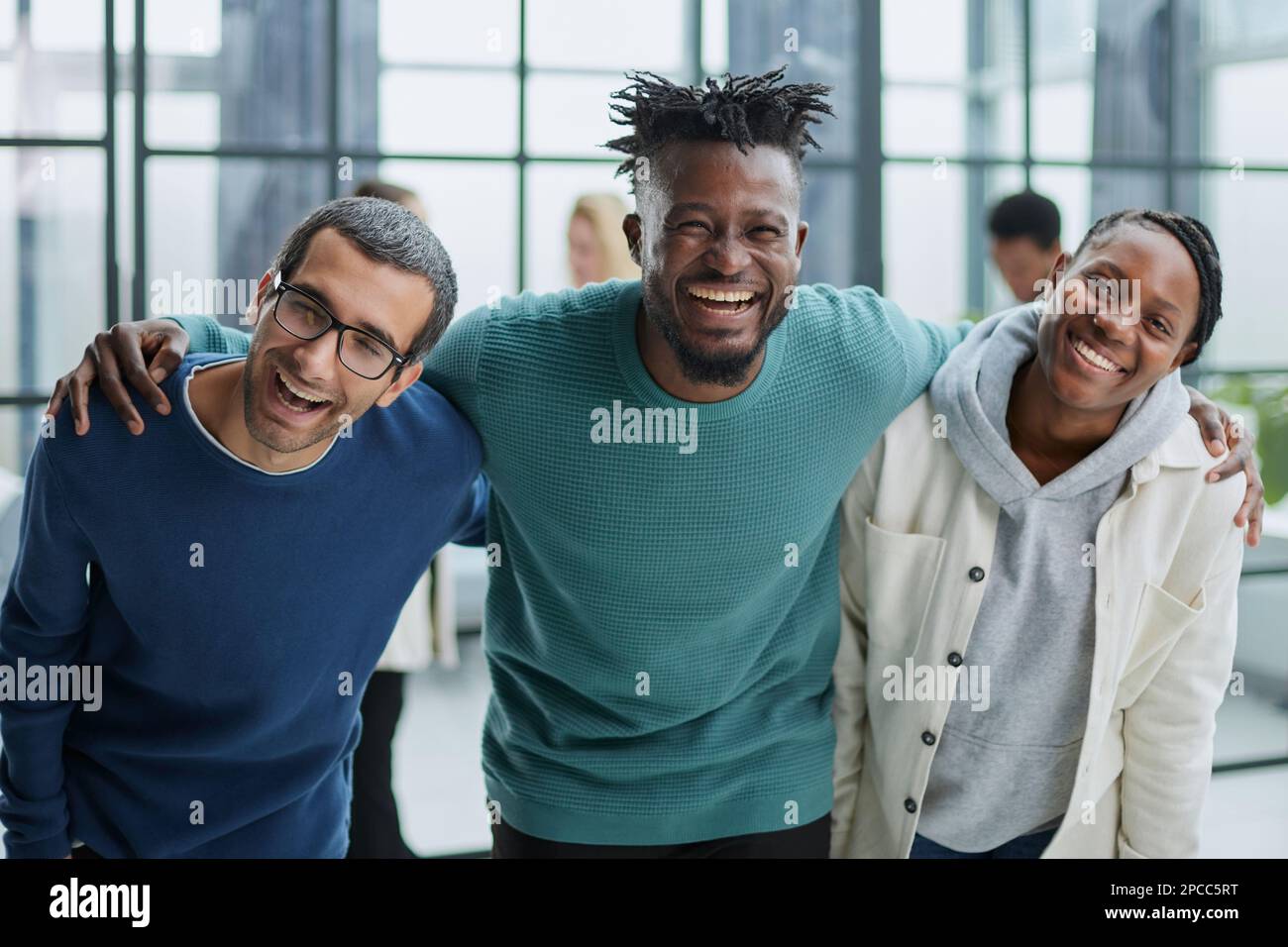 Happy diverse professional business team standing in the office and ...