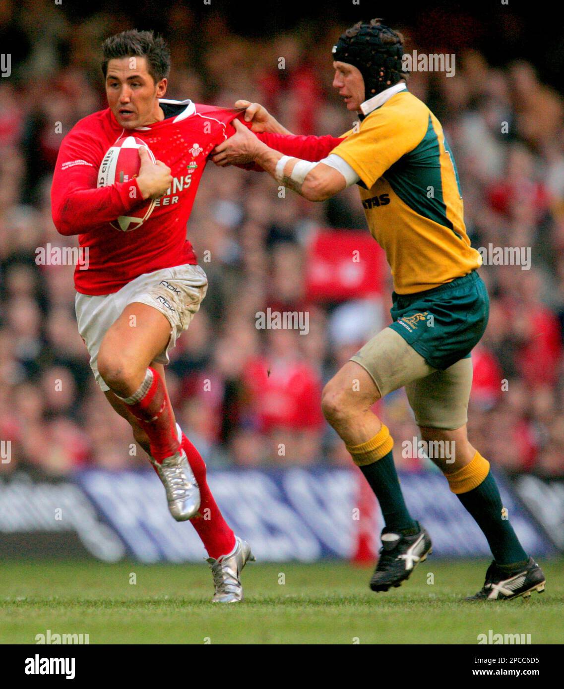 Clyde Rathbone Rugby Wales' Gavin Henson, left, is tackled by Australia's Clyde Rathbone ...