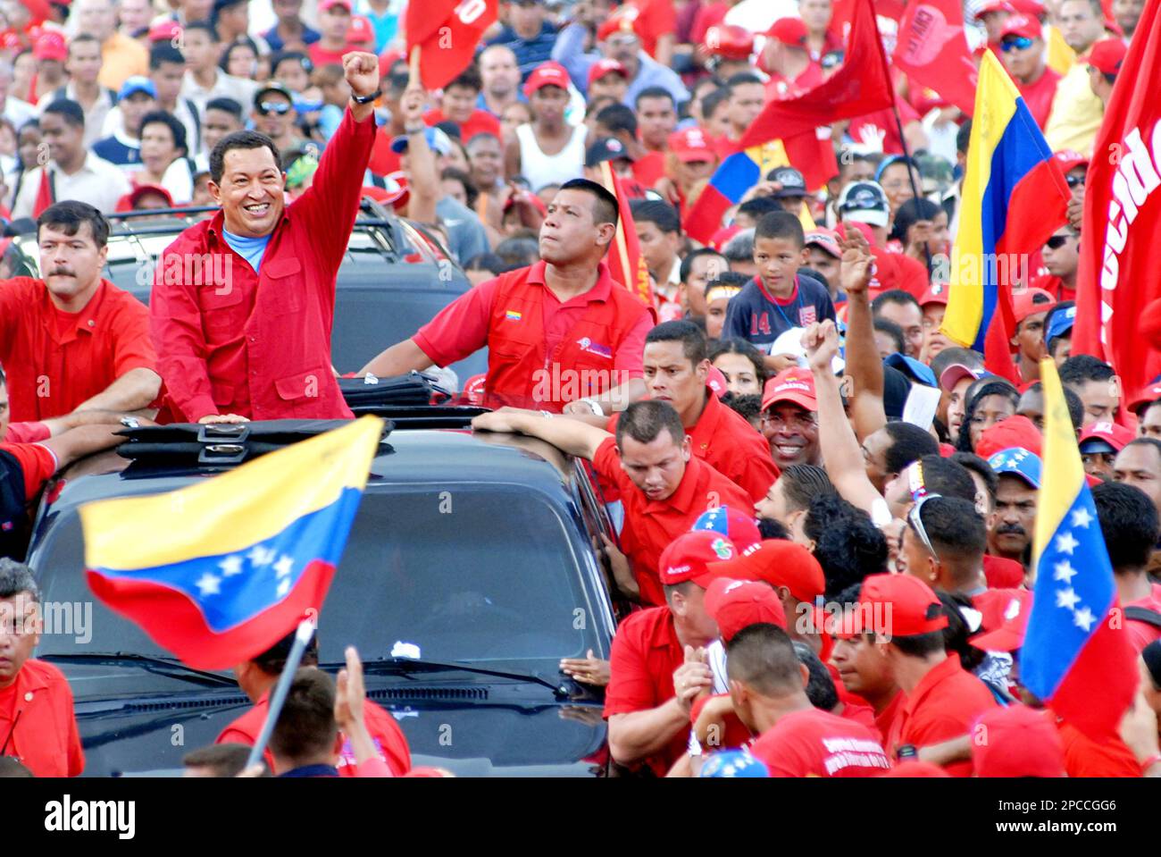 Venezuelan President Hugo Chavez, left, greets his supporters during a