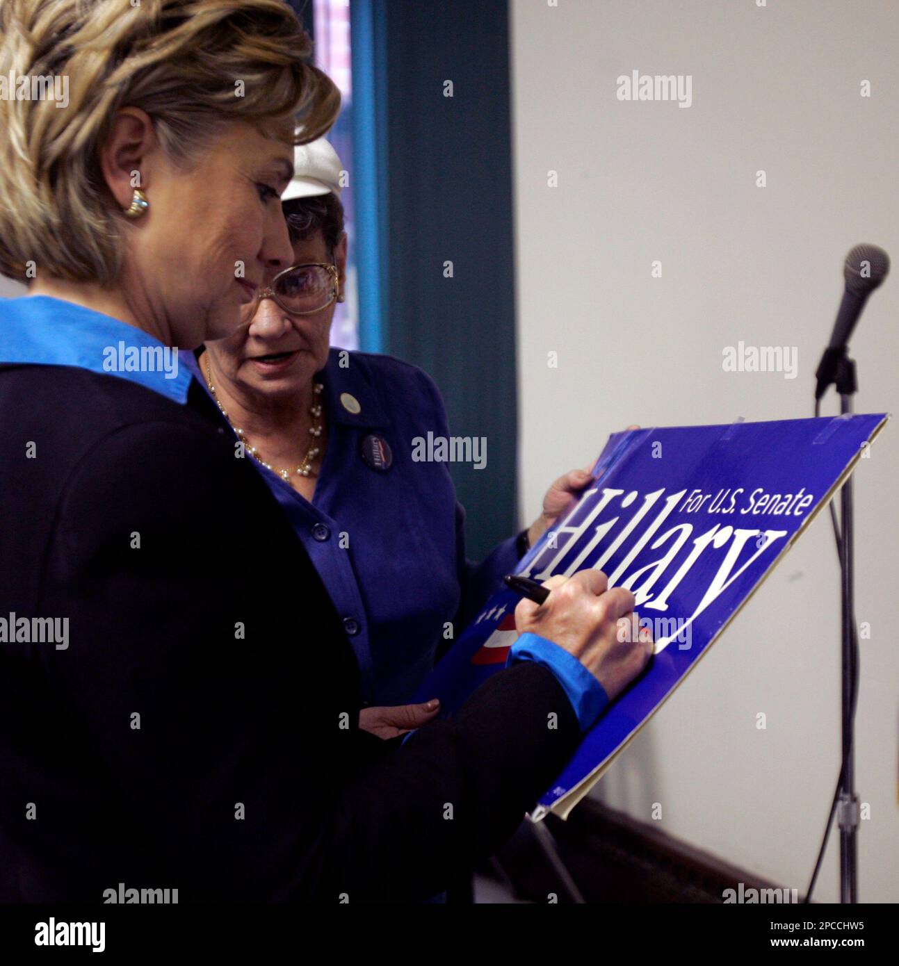 Sen. Hillary Rodham Clinton, DN.Y., signs a reelection sign for an