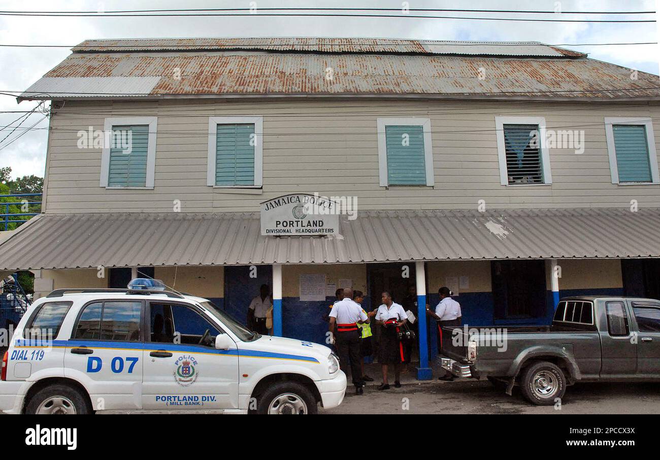People stand outside the Port Antonio police station, where