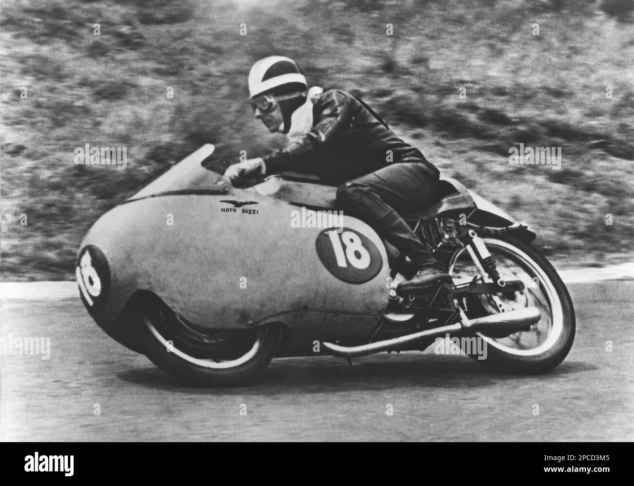 1955 , Isle of Man , GREAT BRITAIN :  BILL LOMAS ( 1928 -  2007) on MOTO GUZZI 350cc . Lomas was an English former Grand Prix motorcycle road racer . He was a two-time World Champion  and a two-time Isle of Man TT winner . He won the 1955 and 1956 350cc world championship as a member of the Moto Guzzi factory racing team . In the 1956 season, he rode the famous V8 Moto Guzzi Grand Prix race bike. Lomas was also an accomplished trials rider.  - SPORT - MOTOCICLISMO - MOTO - gara motociclistica - corridore motociclistico - race - corsa  - portrait - ritratto - HISTORY PHOTO - FOTO STORICA STORIC Stock Photo