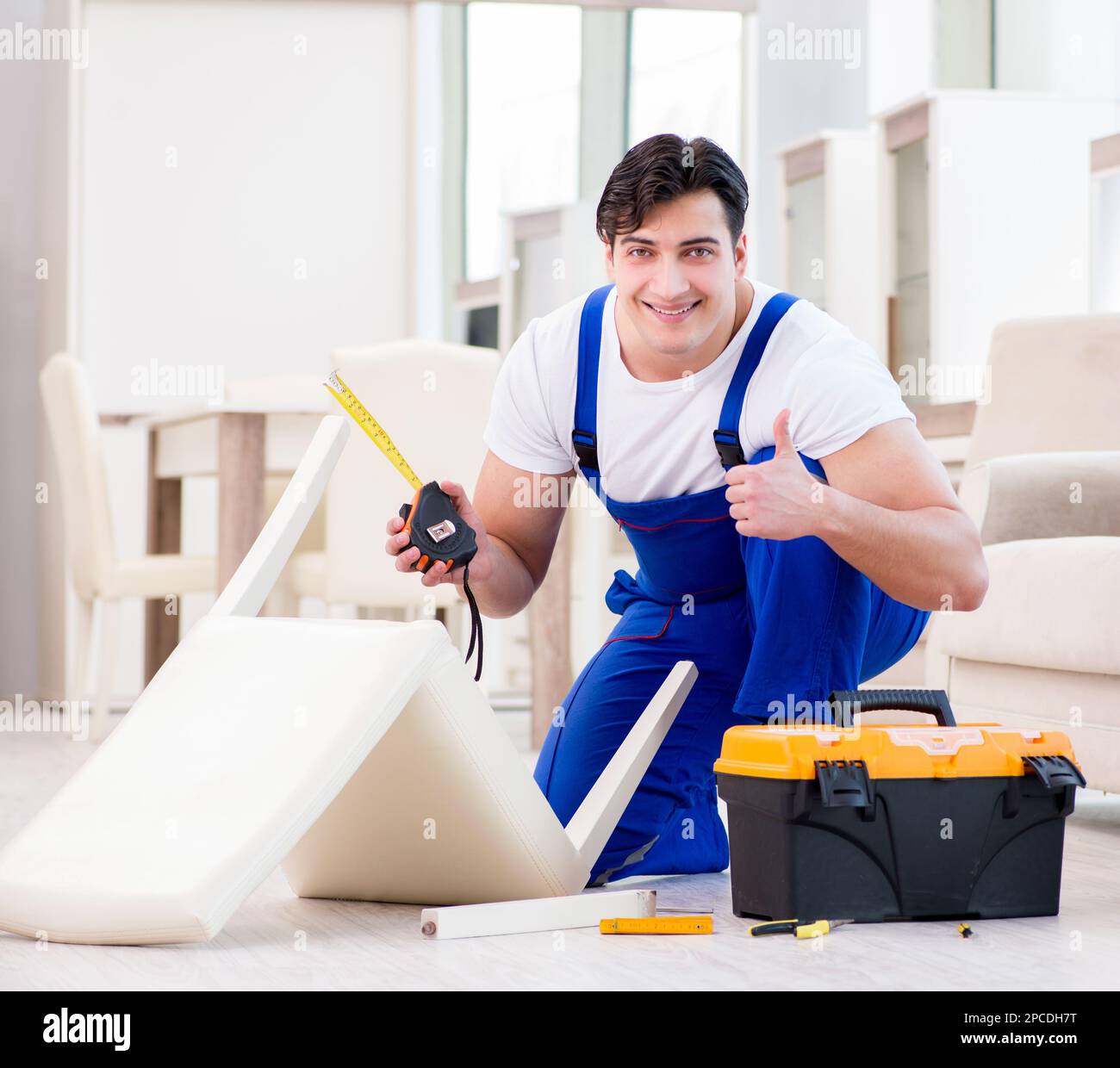 The furniture repairman working in store Stock Photo Alamy