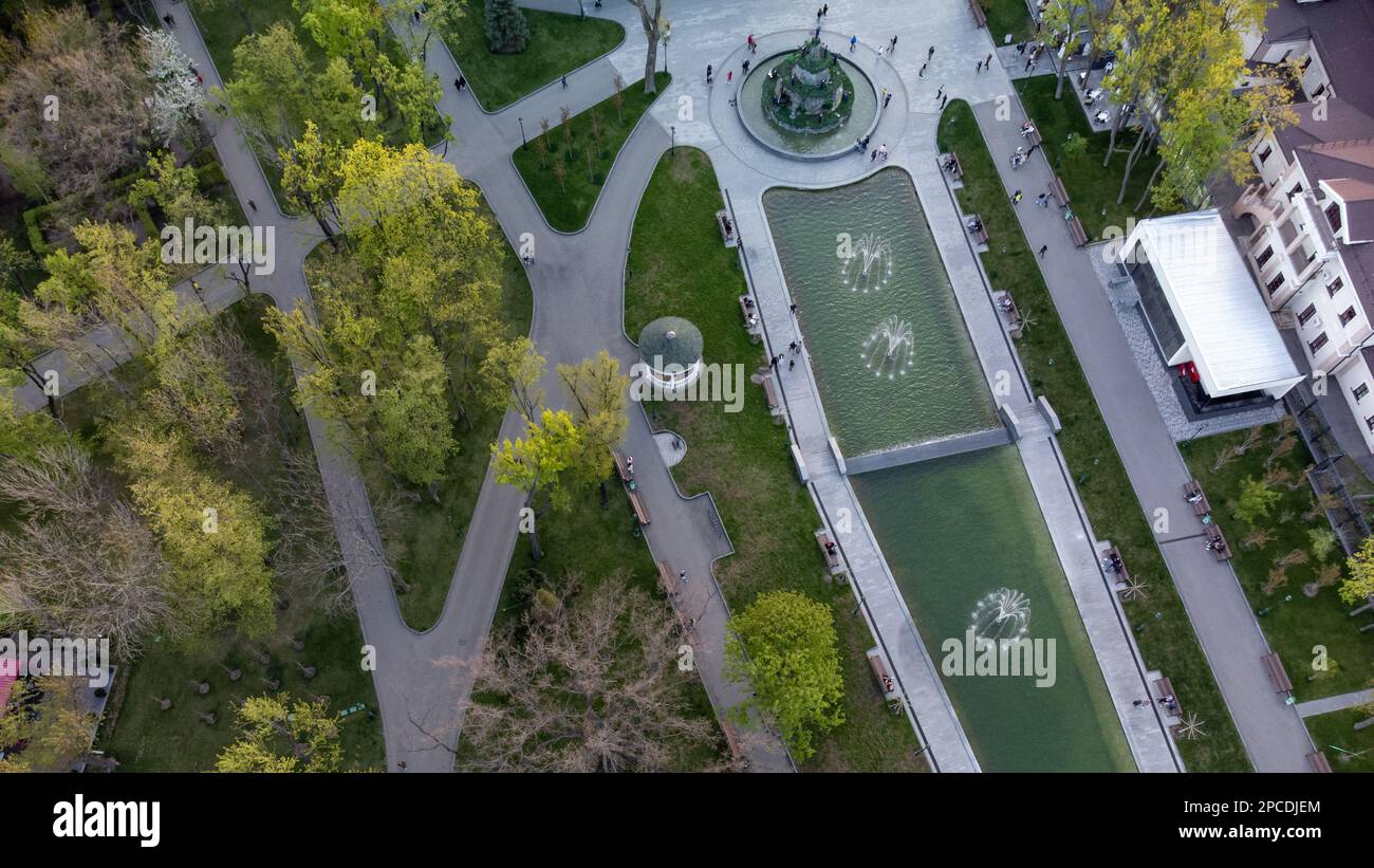 Aerial look down view on fountains in green spring Shevchenko City Garden. Tourist attraction in modern city park, recreation in Kharkiv, Ukraine Stock Photo