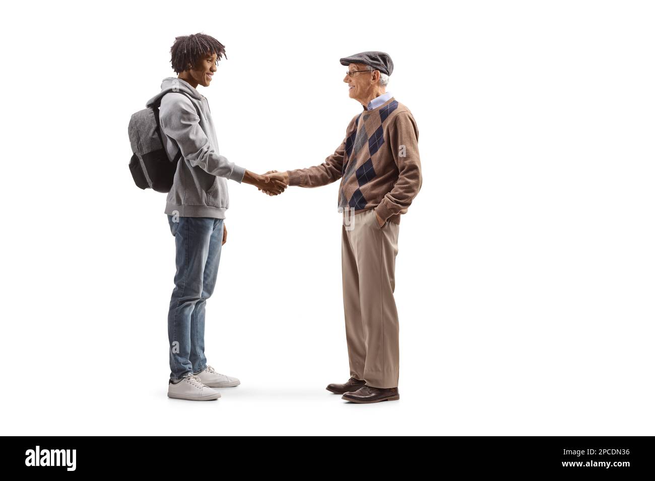 Full length profile shot of an african american male student and a caucasian senior man shaking hands isolated on white background Stock Photo