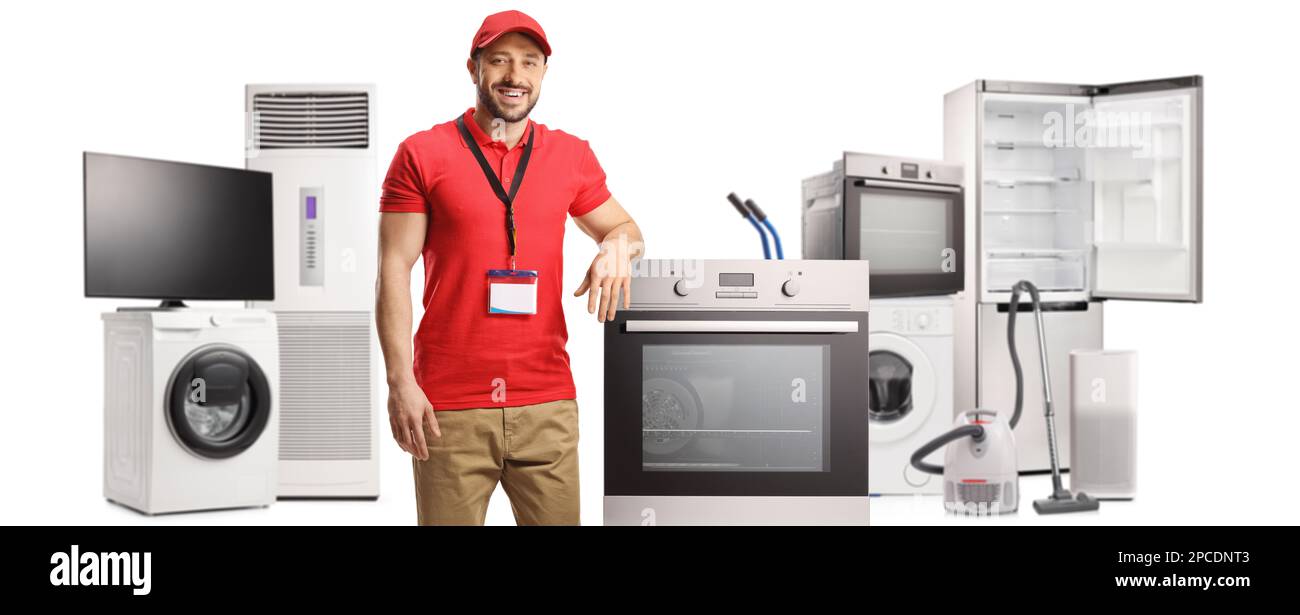 Salesman leaning on an oven and other electrical appliances isolated on white background Stock Photo