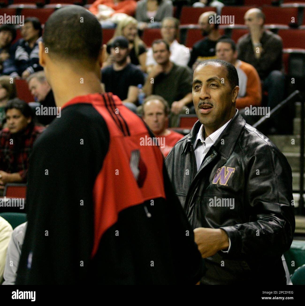 University of Washington head basketball coach Lorenzo Romar, right, greets  his former player Brandon Roy, left, now a rookie guard with the Portland  Trail Blazers, during warm-ups for an NBA basketball exhibition
