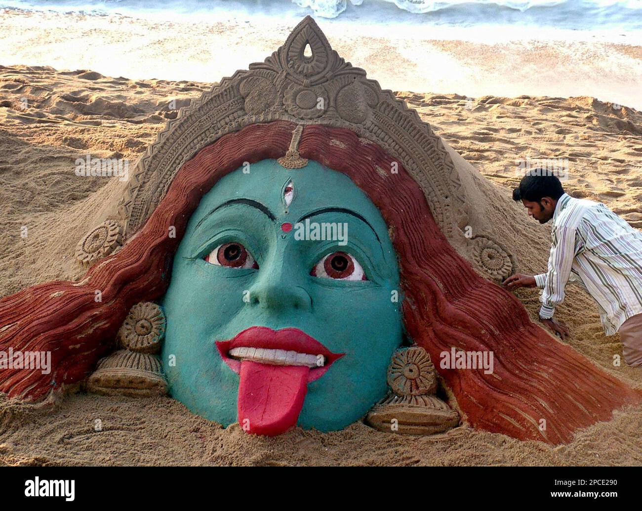 Sand artist Sudarshan Pattnaik makes a sculpture of Hindu Goddess Kali