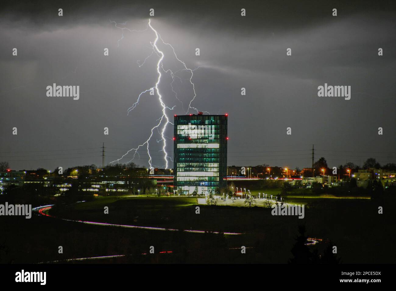 Esslingen, Germany. 13th Mar, 2023. Lightning strikes behind an office complex in Esslingen. On Monday evening, a violent thunderstorm passed over Esslingen, bringing heavy rain and hail. Credit: Sdmg/SDMG/dpa/Alamy Live News Stock Photo
