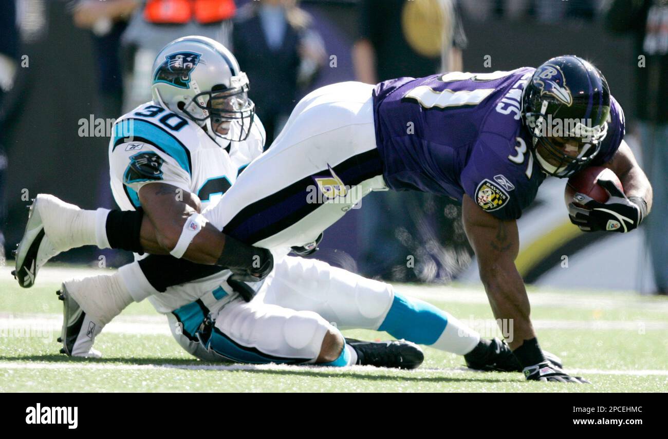 Baltimore Ravens running back Jamal Lewis (31) breaks a tackle attempt by  Cleveland Browns defensive lineman Tyrone Rogers, left, in the first  quarter Sunday, Nov. 7, 2004, in Baltimore. Lewis returned to