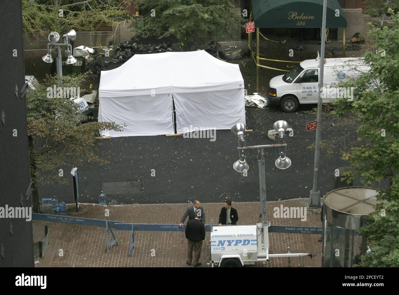 Parts from a plane wreckage lie strewn on the ground as investigators
