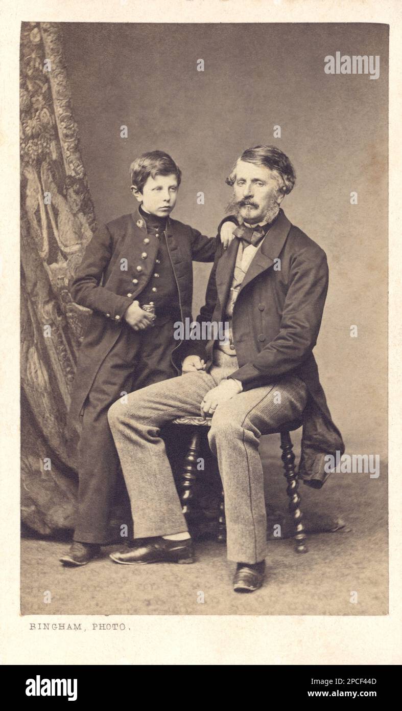 1870 ca , PARIS , FRANCE  : A boy in college uniform with  his father. Photo by BINGHAM , Paris  - PADRE E FIGLIO - Papà   - FOTO STORICHE - HISTORY PHOTOS -   - BAMBINO - BAMBINI - CHILDREN -  OTTOCENTO - 800's - '800 - FASHION - MODA - tie bow - cravatta - papillon - baffi - moustache - beard - barba - FAMIGLIA - FAMILY - collegio - collegiale - child - children - INFANZIA - CHILHOOD - FIGLIO - SON  - scolaro - studente - scholar -----  Archivio GBB Stock Photo