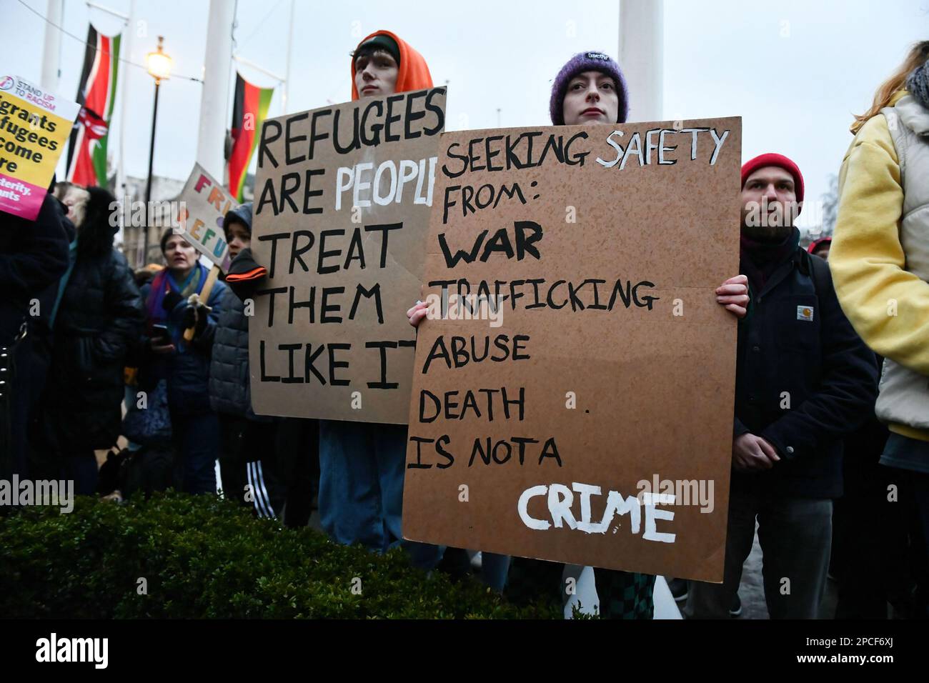 London, UK. 13th Mar, 2023. Protesters hold placards listing potential reasons people can become refugees during a pro-migration rally in Parliament Square, London. Pro migration activists gathered in Parliament Square, today evening to protest against the proposed Nationality and Borders bill, which if enacted, will make sweeping changes to way the UK authorities handle migrants, refugees and asylum seekers. Credit: SOPA Images Limited/Alamy Live News Stock Photo