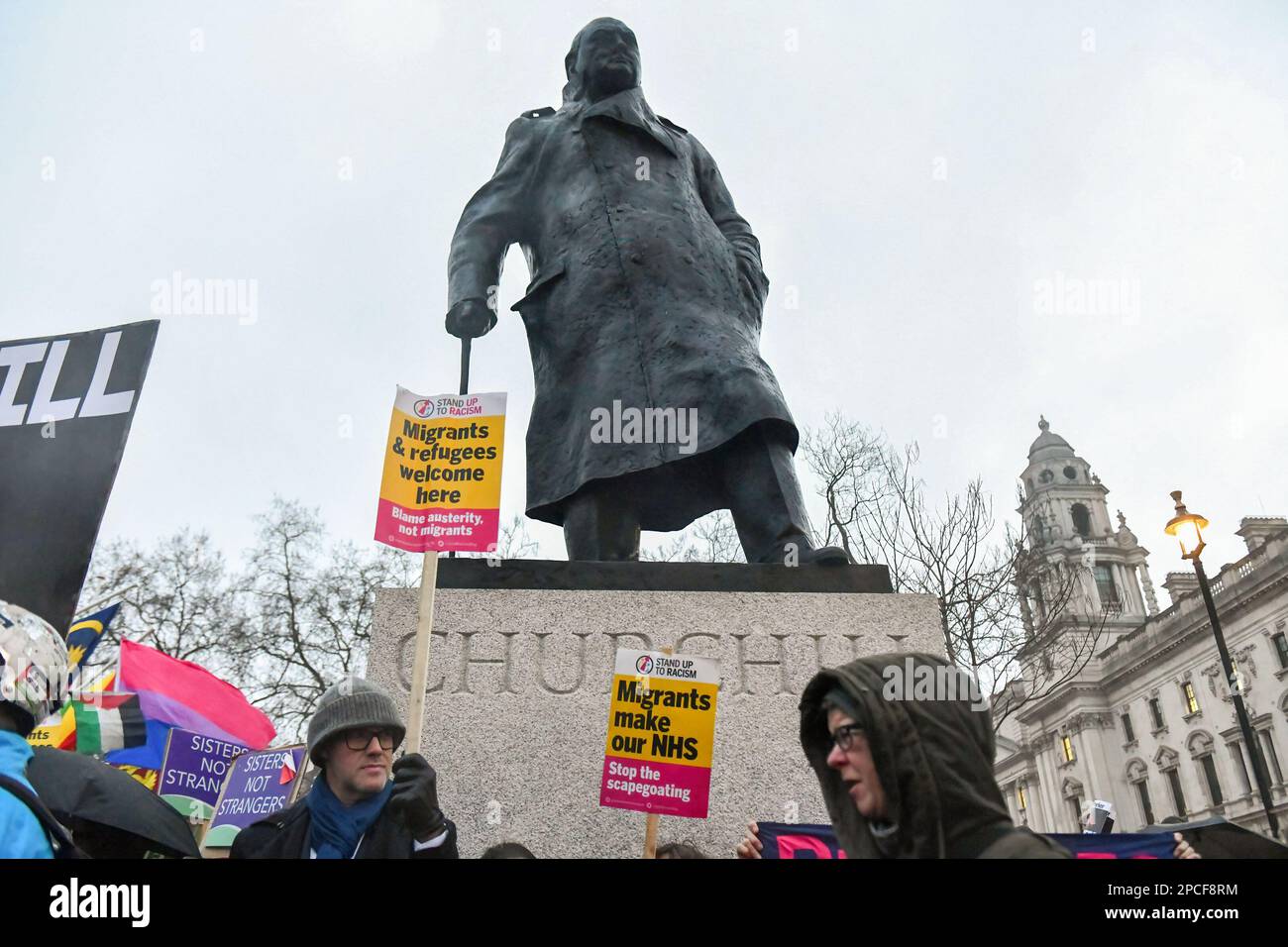 London, UK. 13th Mar, 2023. Protesters hold placards below a statue of Winston Churchill during a pro-migration rally in Parliament Square, London. Pro migration activists gathered in Parliament Square, today evening to protest against the proposed Nationality and Borders bill, which if enacted, will make sweeping changes to way the UK authorities handle migrants, refugees and asylum seekers. (Photo by Mike Ruane/SOPA Images/Sipa USA) Credit: Sipa USA/Alamy Live News Stock Photo
