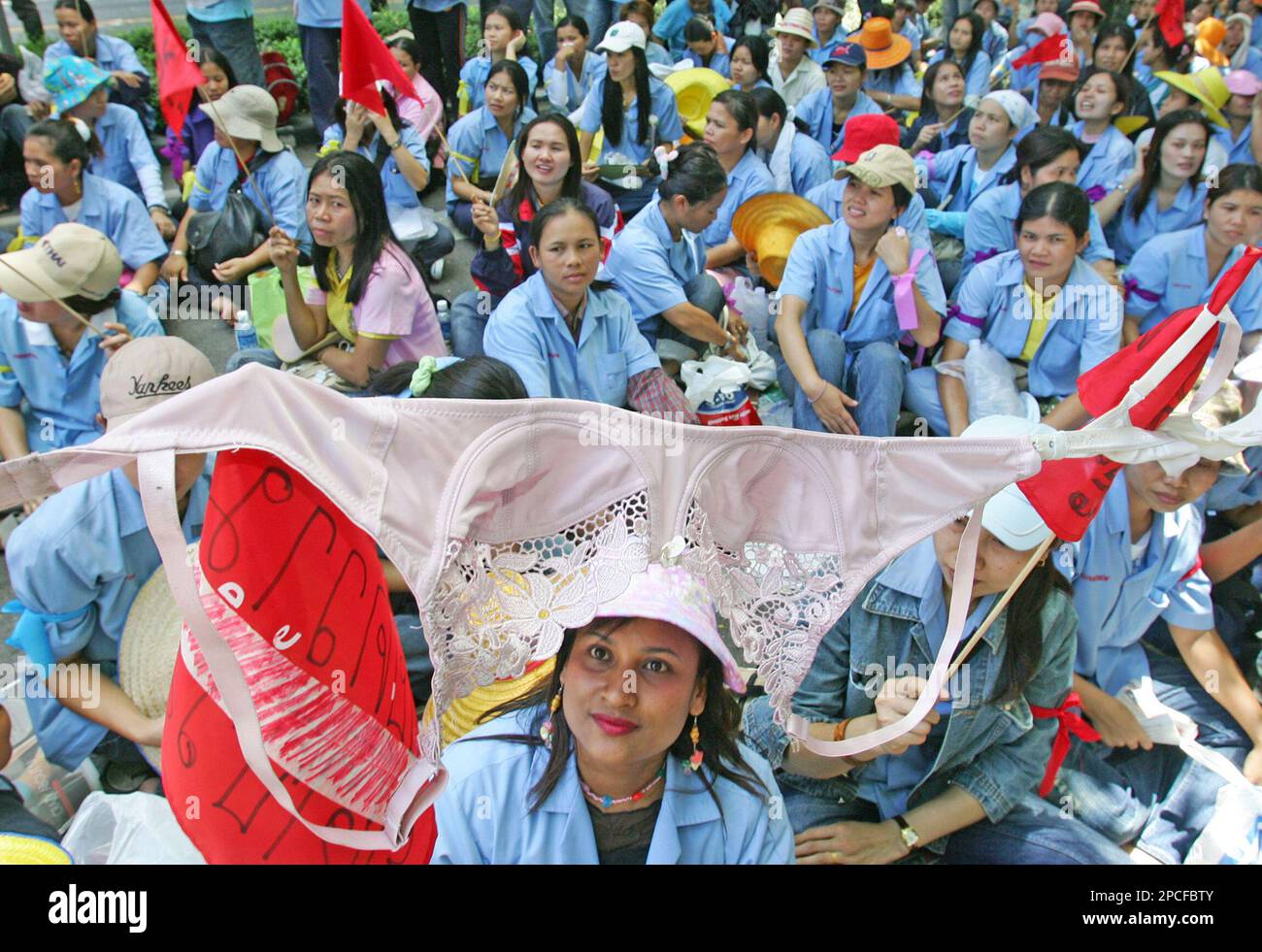 A protester hoists a bra as about 500 workers from a Thai Bra factory that  manufactures bras for Victoria's Secret, The Gap and other American  companies march outside the U.S. Embassy in