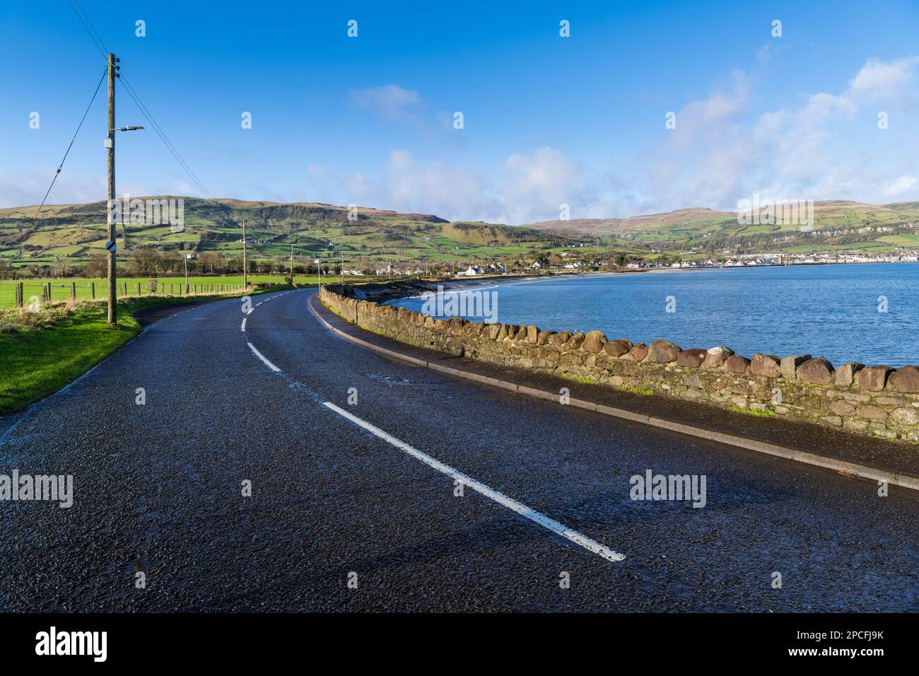 Highway of the Causeway Coastal Route curves towards Carnlough along Northern Ireland's Antrim Coast Stock Photo