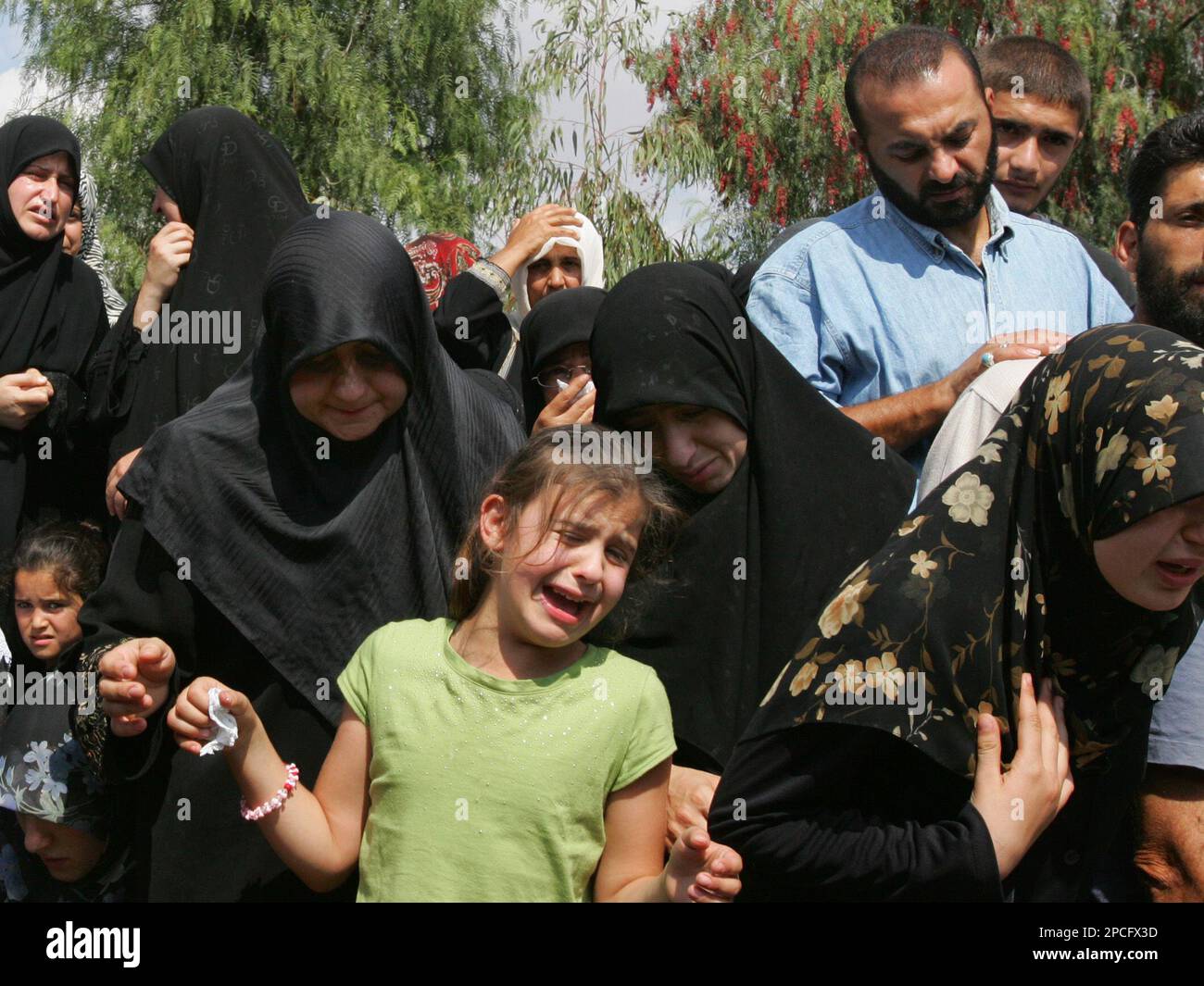 Seven-year-old Rima, center, cries as the body of her father, Lebanese ...