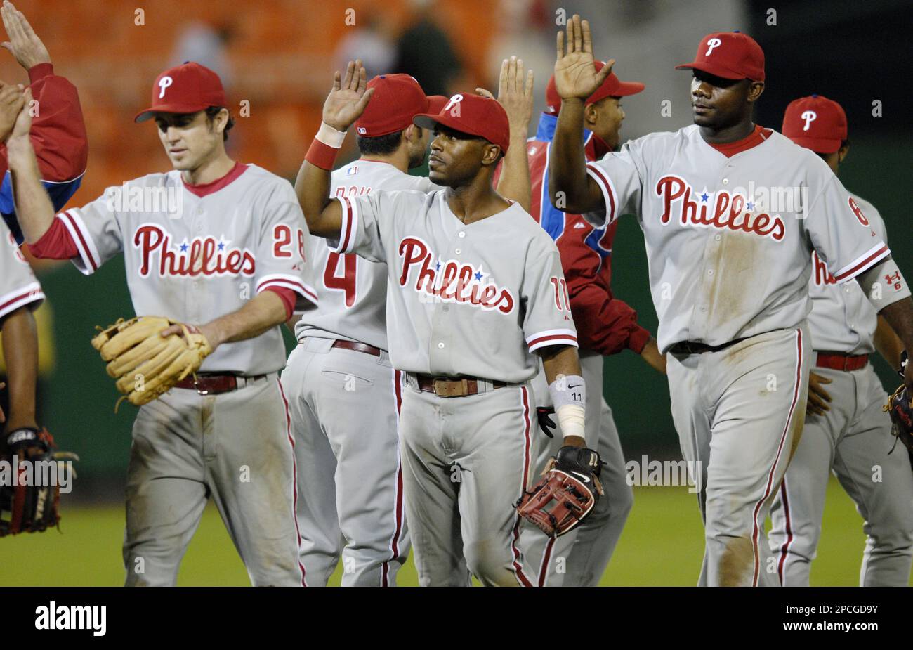 Philadelphia Phillies' Chase Utley (26), Jimmy Rollins (11) and Ryan Howard  (6) celebrate the Phillies' 8