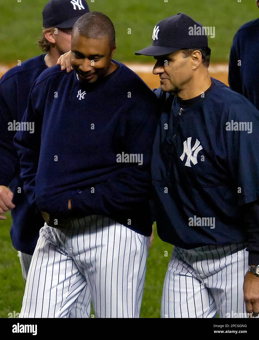 New York Yankees manager Joe Torre, right, walks off the field with Bernie  Williams after the Yankees beat the Baltimore Orioles, 5-4, during MLB  baseball Tuesday, Sept. 26, 2006 at Yankee Stadium