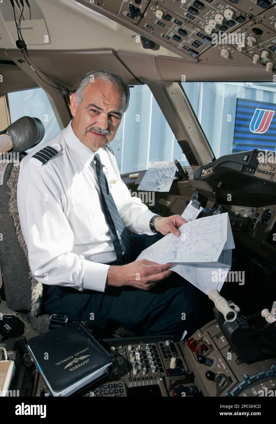 United Airlines pilot Capt. Allan Engelhardt, 59, sits inside the cockpit of a Boeing 777 at