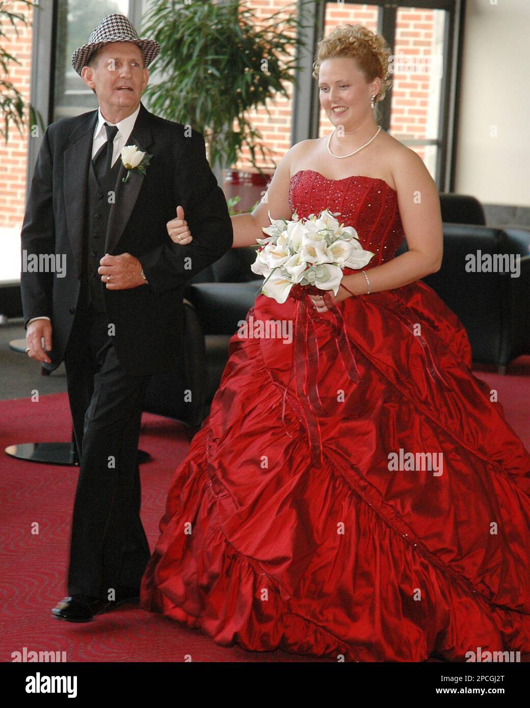 Roger Beddingfield escorts his daughter, Carson, down the aisle, as he