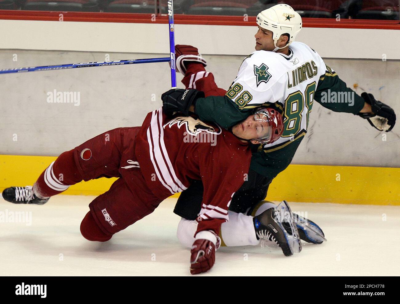 Dallas Stars center Eric Lindros (88) hauls Phoenix Coyotes defenseman Keith Ballard to the ice in the first period of an NHL preseason hockey game Wednesday, Sept. 20, 2006, in Glendale, Ariz. ( Dallas Stars center Eric Lindros (88) hauls Phoenix Coyotes defenseman Keith Ballard to the ice in the first period of an NHL preseason hockey game Wednesday, Sept. 20, 2006, in Glendale, Ariz. (