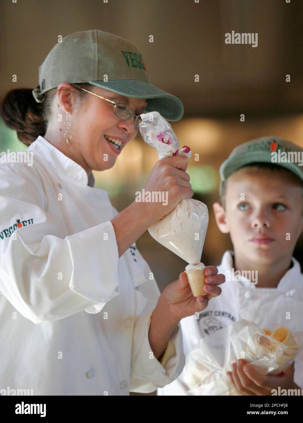 Rebecca Posey, left, prepares a strawberry ice-cream cone as Gabe ...