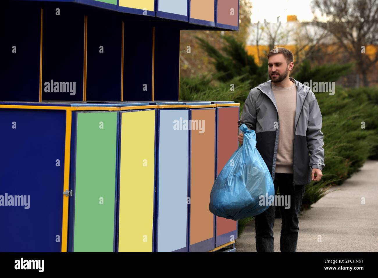 Man throwing garbage at recycling point outdoors Stock Photo Alamy