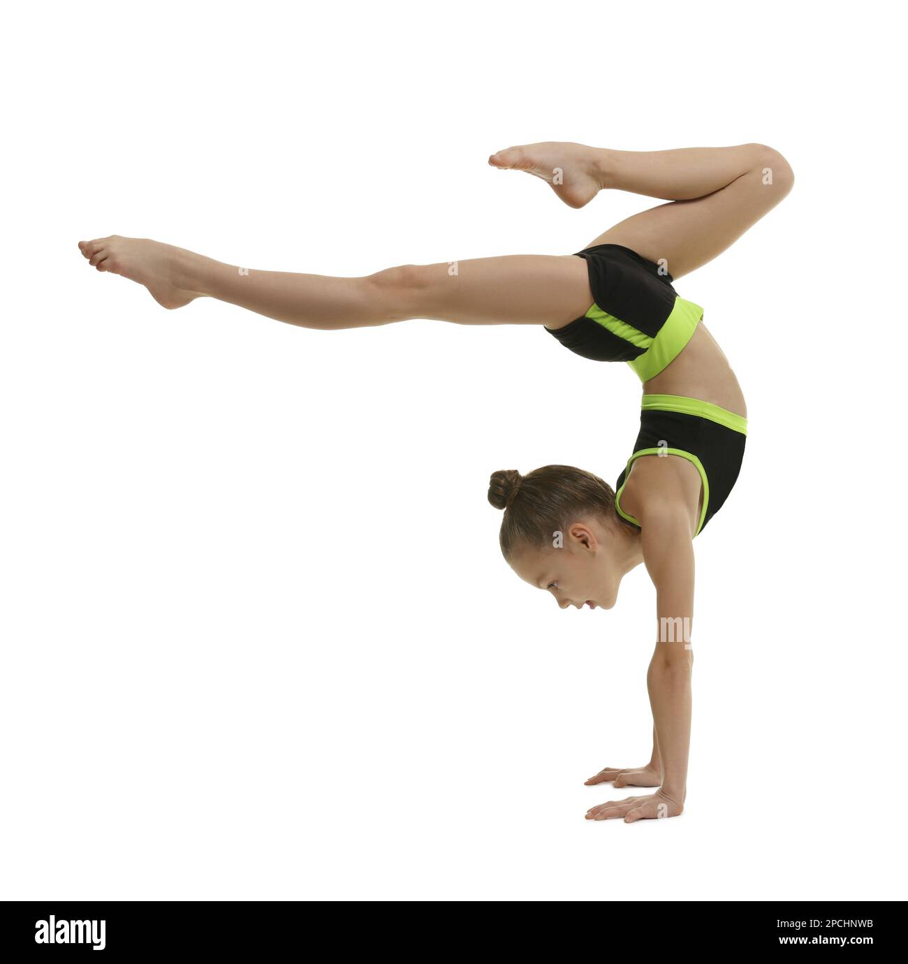 Cute little gymnast doing handstand on white background Stock Photo
