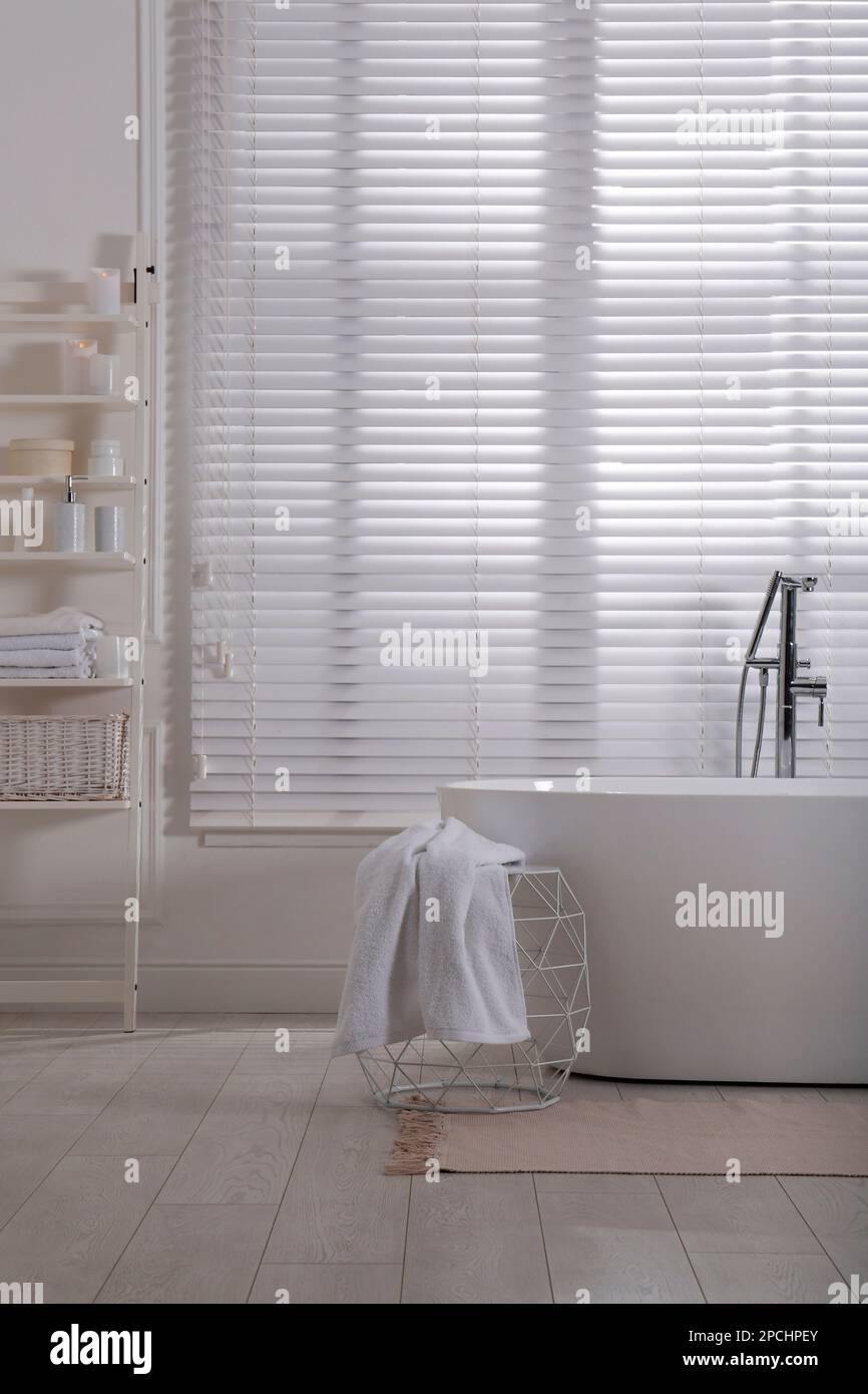 Minimal bathroom interior with modern white tub Stock Photo - Alamy
