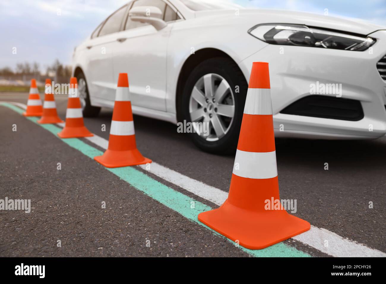 Modern car on test track with traffic cones, closeup. Driving school ...
