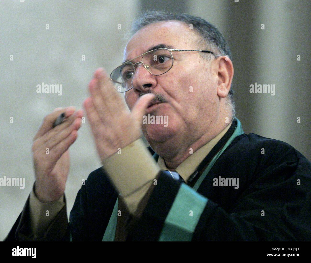Defence lawyer Badie Aref speaks to the chief judge during the trial of