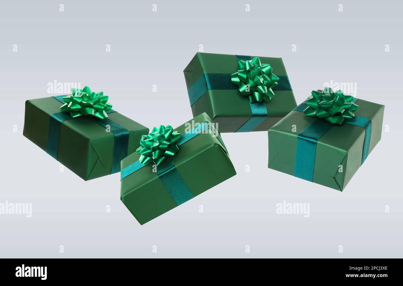 Beautifully wrapped gift boxes flying on light background Stock Photo
