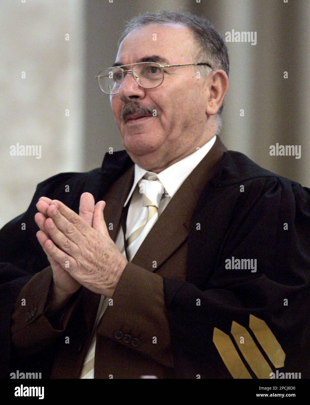 Defence lawyer Badie Aref speaks to the chief judge during the trial of