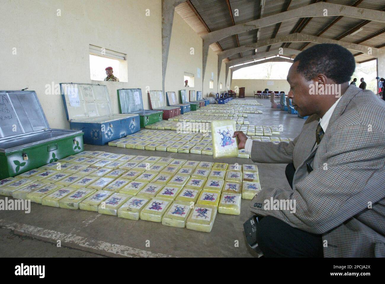 ** FILE ** A Kenyan plain clothes officer examines the largest seizure