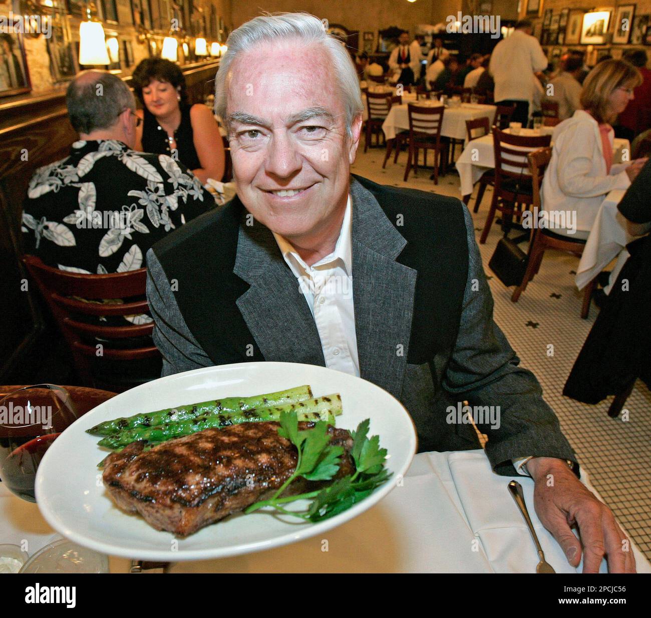 Bill Kurtis, television show host and former news anchor, holds a plate of  "designer beef" from his Tallgrass Beef Company Thursday, Aug. 31, 2006, at  Harry Caray's restaurant in Chicago. Kurtis, whose