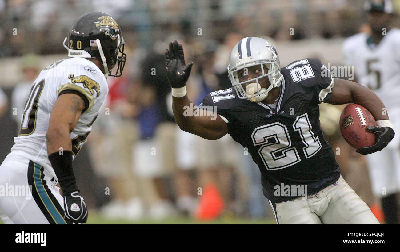Dallas Cowboys running back Julius Jones, right, looks to fend off