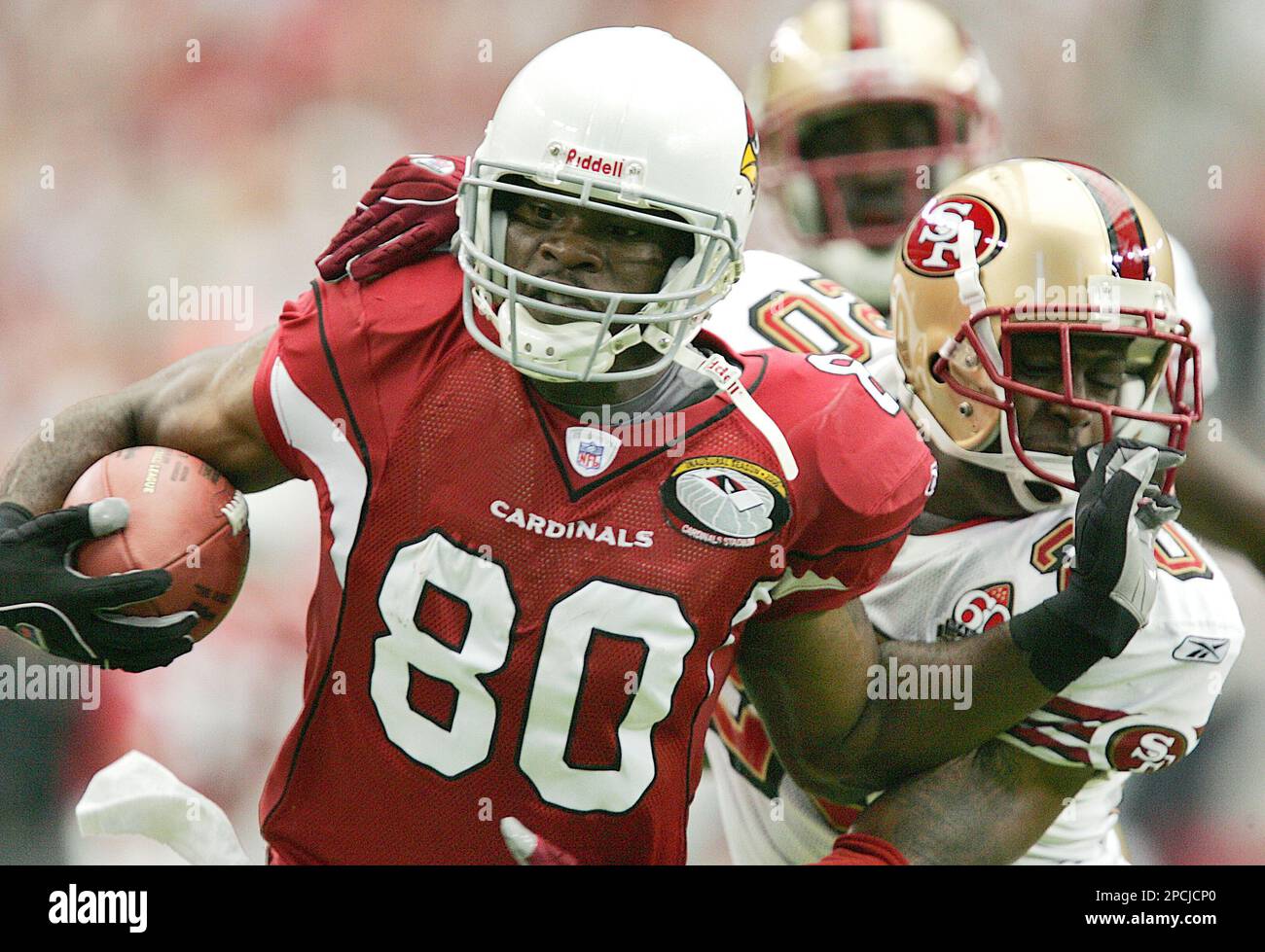 Arizona Cardinals receiver Bryant Johnson (80) is pulled down by San  Francisco 49ers Mike Adams (20) during the first quarter of NFL football  action Sunday, Sept. 10, 2006 at Cardinals Stadium in