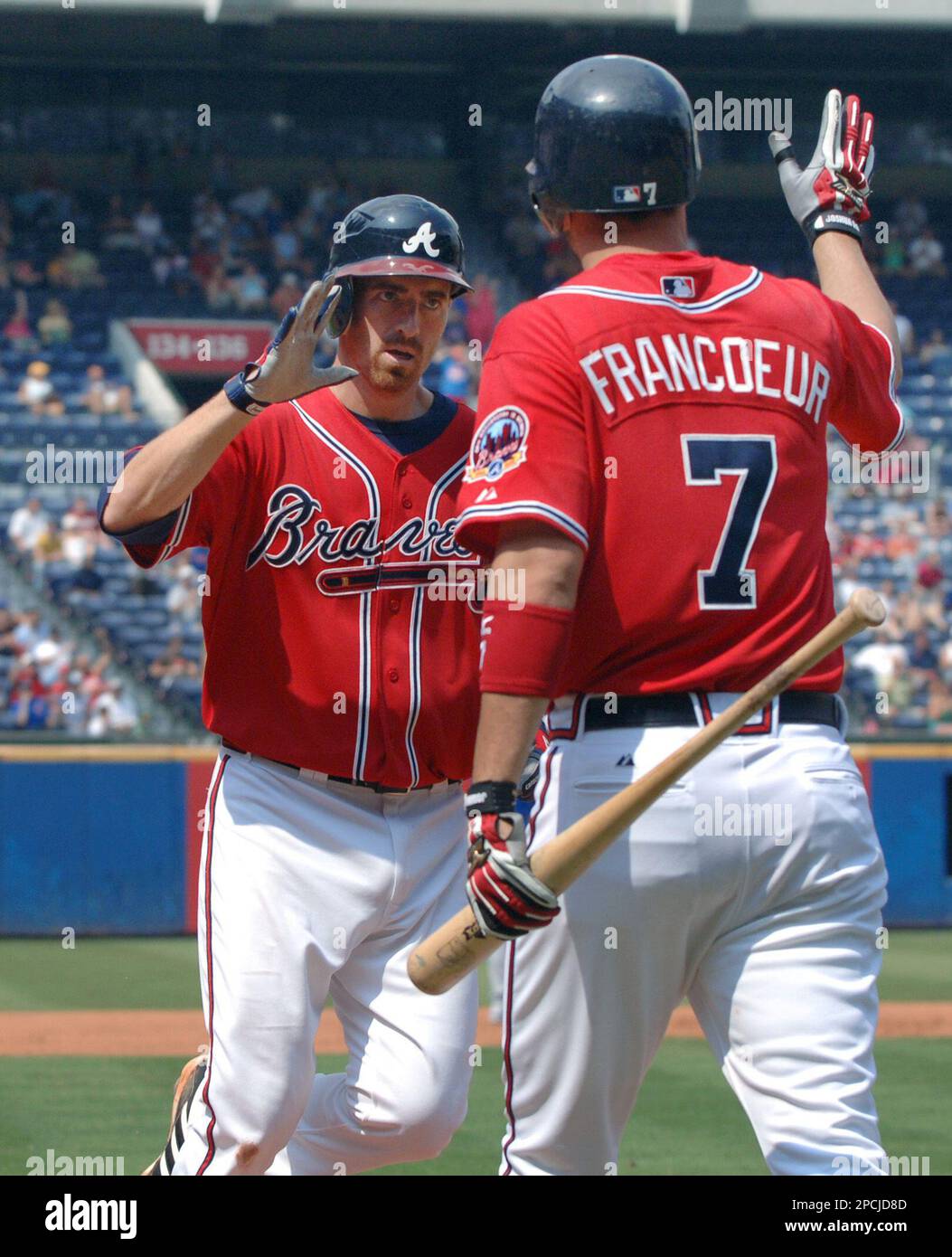 FILE ** Atlanta Braves' Jeff Francoeur and Adam LaRoche, rear, celebrate  after Francoeur drove in the winning run with a base hit in the bottom of  the 10th inning of a