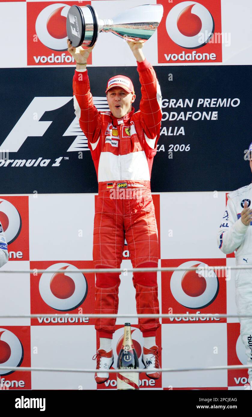 Ferrari driver Michael Schumacher jumps on the podium as he