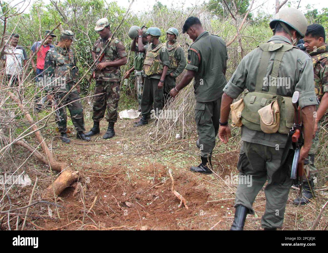 Sri Lankan soldiers stand guard at the scene of an explosion in ...