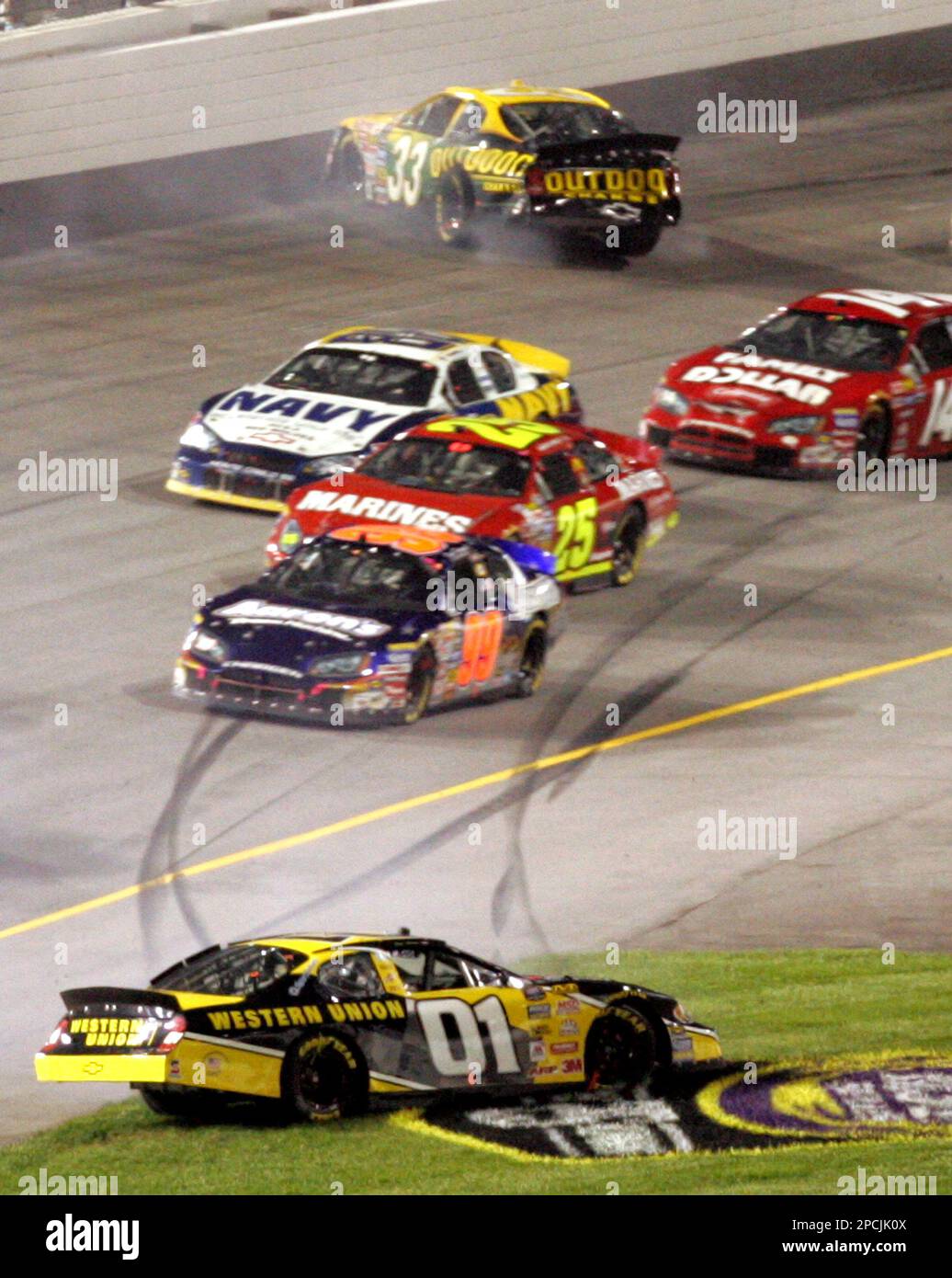 Jay Sauter (01) spins out in the infield as Ron Hornaday Jr. (33) spins  near the wall as other drivers pass by during the NASCAR Busch Series'  Emerson Radio 250 auto race