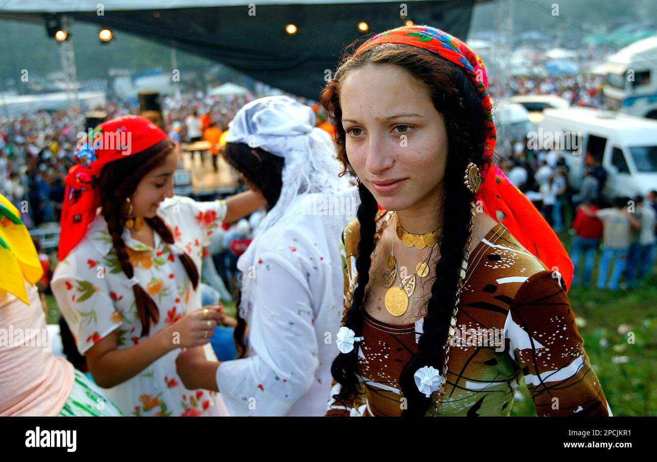 A Romanian Gypsy girl looks on in Costesti, Romania, 250 west of Bucharest,  Friday Sept. 8 2006 during annual celebrations which gathered thousands of  Gypsies and Romanians. Romania, a country that hopes