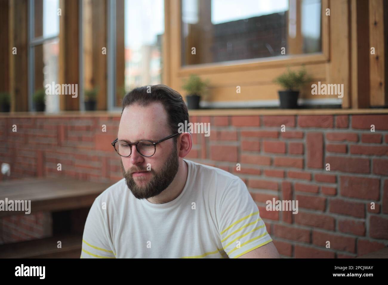 Man looking down at a coffee shop Stock Photo